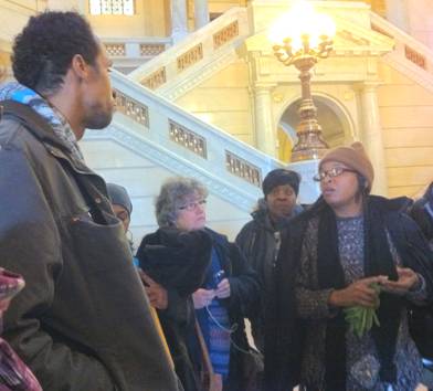 Derrick Stanley and Shandre Delaney debrief with supporters after the hearing