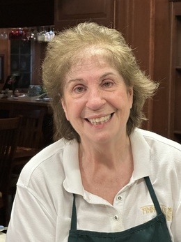 Photo of Rosalie George, Founder and Innkeeper of Annville Inn. Holding flowers from the Inn's botanical gardens.