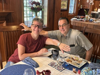 Coupleseated in Annville Inn's Main Dining Room showing off their engagement ring.