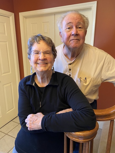 Couple, married over 50 years, standing at the foot of the stairs going up, at Annville Inn