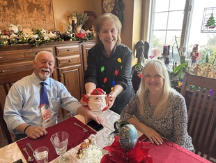 Photo of Rosalie George, Founder and Innkeeper of Annville Inn. Holding flowers from the Inn's botanical gardens. Annville Inn News.
