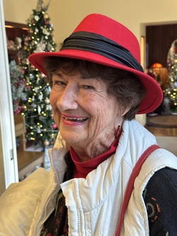 Guest, a lady wearing a bright red hat at Christmas