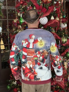 Man in cowboy hat in front of one of Annville Inn's 65 Christmas Trees! He has on a Christmas sweather.