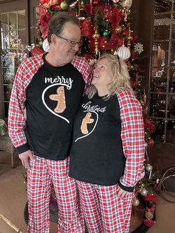 Couple at Annville Inn's 12-ft. tall Christmas Tree. They are wearing matching Christmas PJ's!
