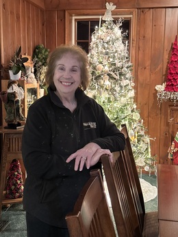 Photo of Rosalie George, Founder and Innkeeper of Annville Inn. Holding flowers from the Inn's botanical gardens.