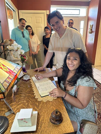 Newly Wed couple signing the Guest Register at Annville Inn. Parents are standing in background.