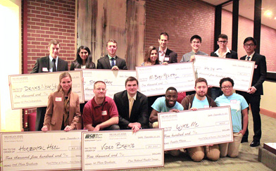 Competition winners with large cardboard checks