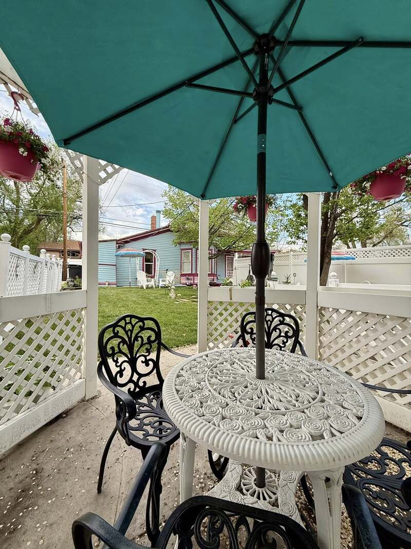 The inviting back garden features flowers and fountains