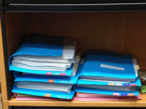 photograph of files and folders in a bookcase