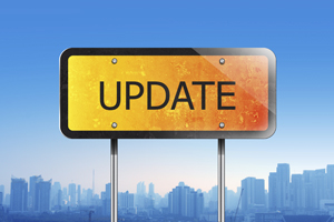 IMAGE: A yellow roadworks sign that has black text on it that says 'UPDATE'. A city skyline is in the background.